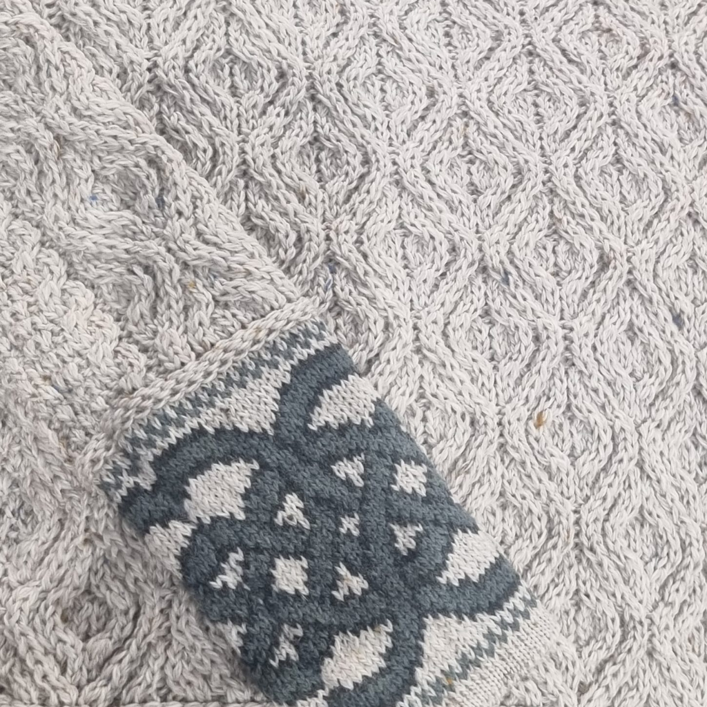 Sleeve and cuff detail showing Celtic knotwork on oatmeal Aran sweater