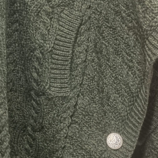 Close-up of Celtic Knot zip and button detail on Aran Funnel Neck Jacket in Army Green.