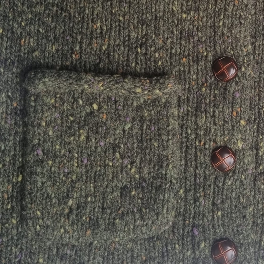 Close-up of Avondale Tweed Cardigan, showcasing wool tweed texture and Aran-style buttons.