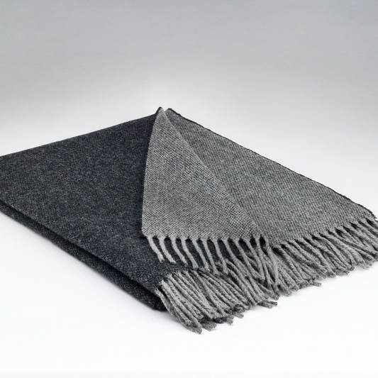 Folded McNutt Charcoal Reversible Throw in dark grey and charcoal, woven in Donegal from 100% merino lambswool