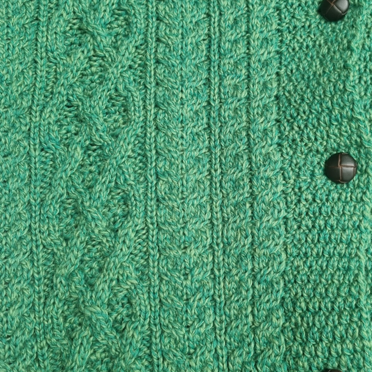 Close-up of Clover Cropped Aran Cardigan – Green Marl Aran stitches