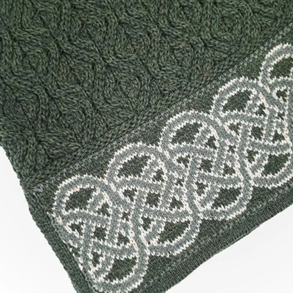 Detailed view of Celtic jacquard hem design on Dark Green Irish cowl neck sweater