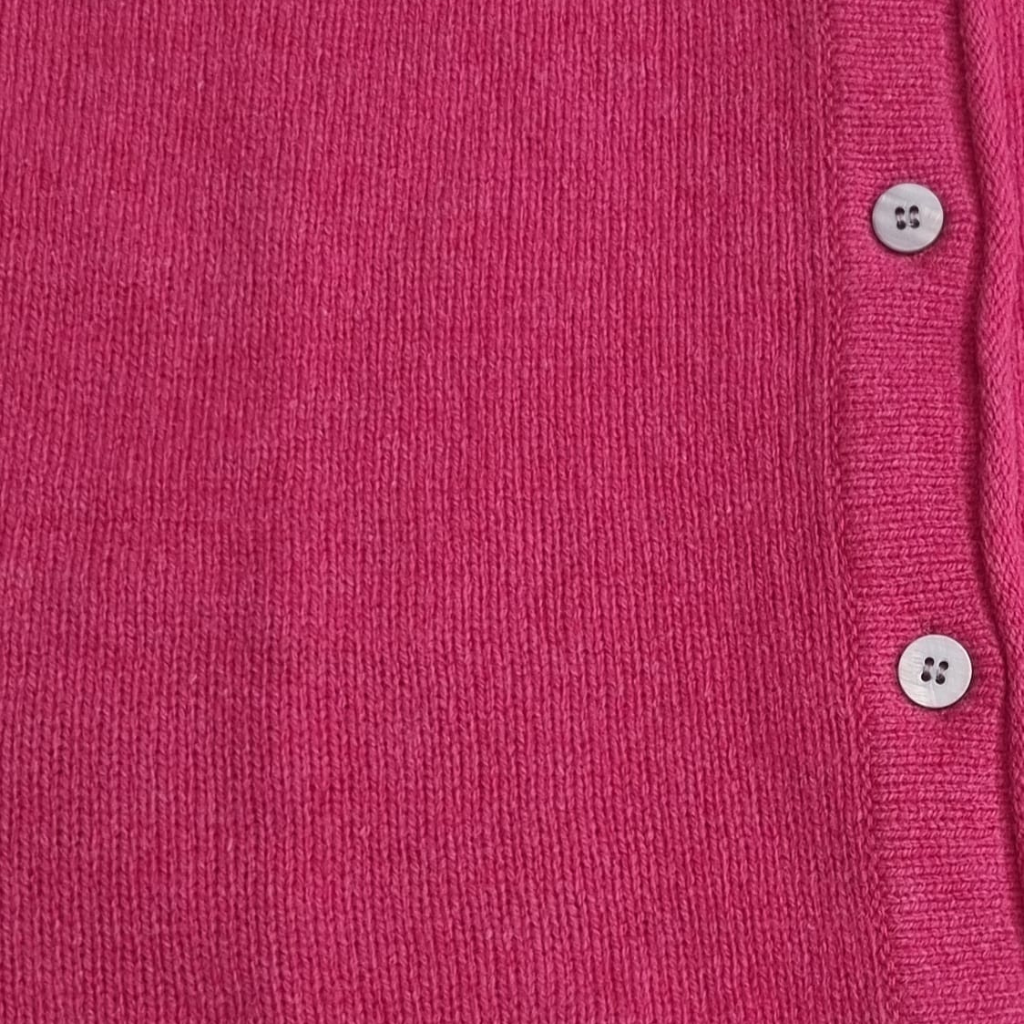 Close-up detail of Killiney Button Cardigan buttons and rose pink wool cashmere fabric