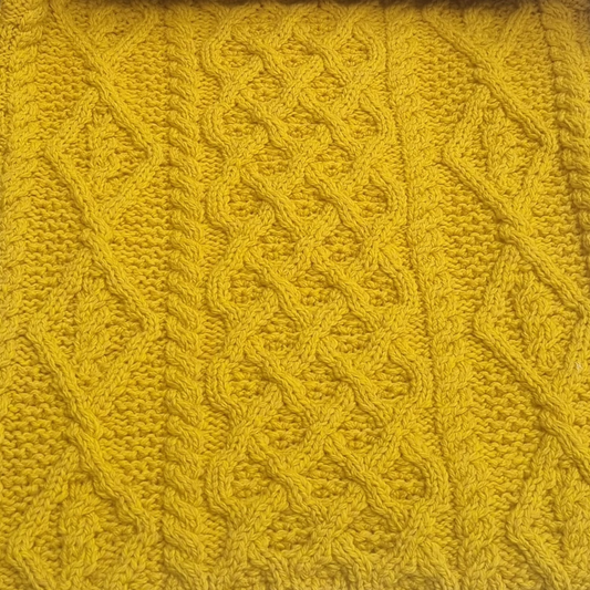 Close-up of lattice, cable and diamond stitches on Lambay Aran Sweater in Sunflower Merino wool