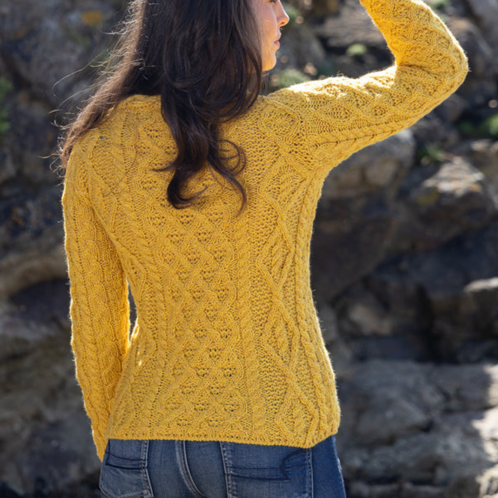 Back view of Lambay Lattice Cable Aran Sweater in Sunflower, women’s Merino wool knit