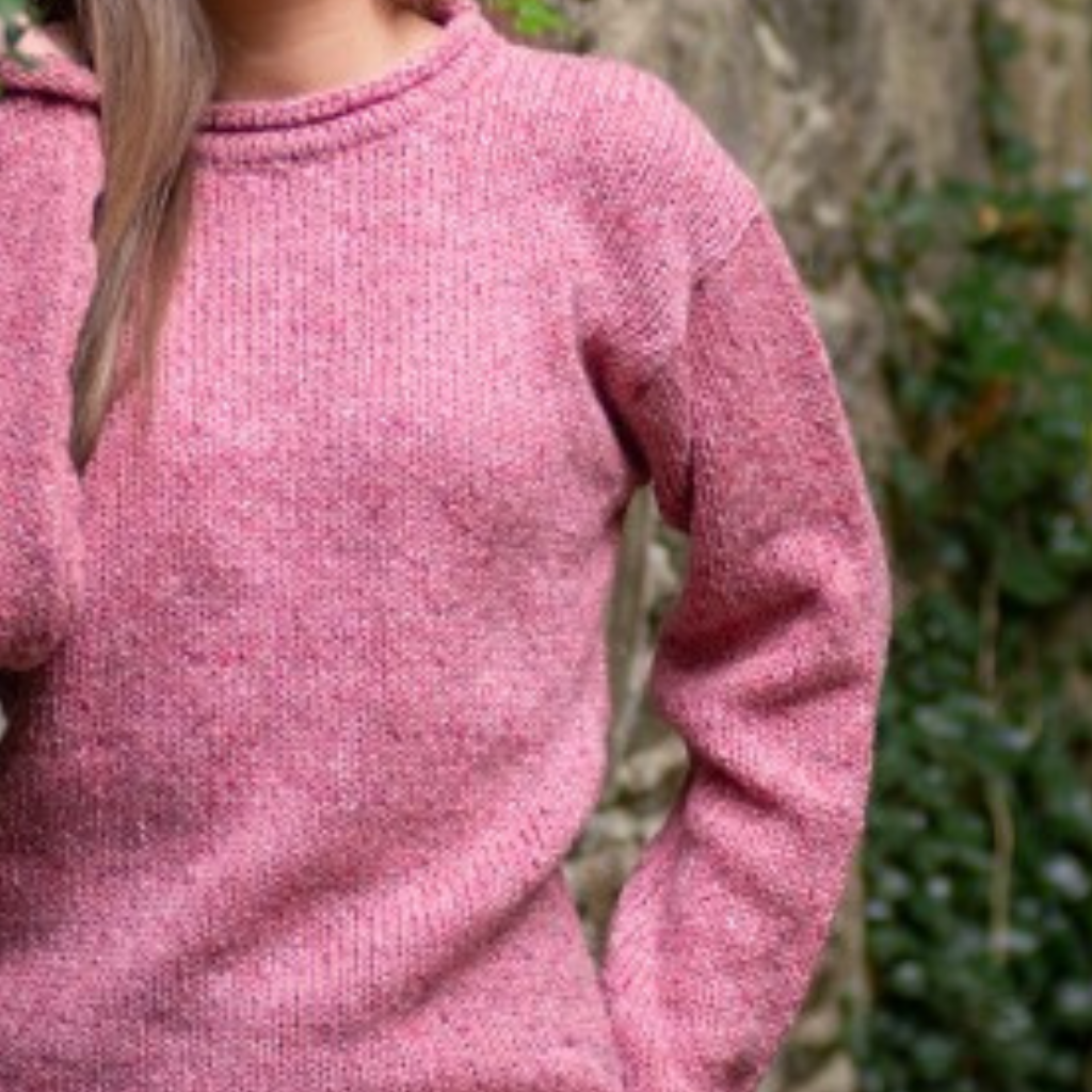 Close-up of rose fleck Donegal wool and basque detail on ladies roll neck tunic