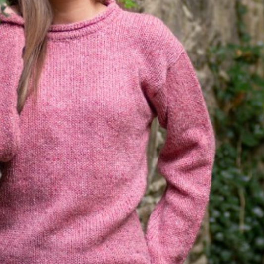 Close-up of rose fleck Donegal wool and basque detail on ladies roll neck tunic