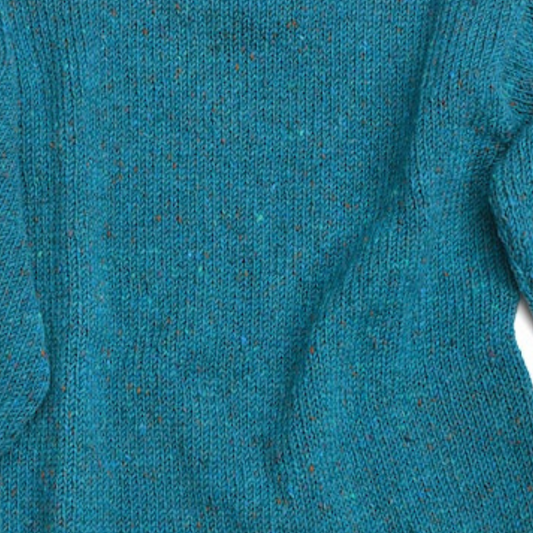 Close-up of turquoise Donegal Tweed wool fabric on unisex roll neck Aran sweater