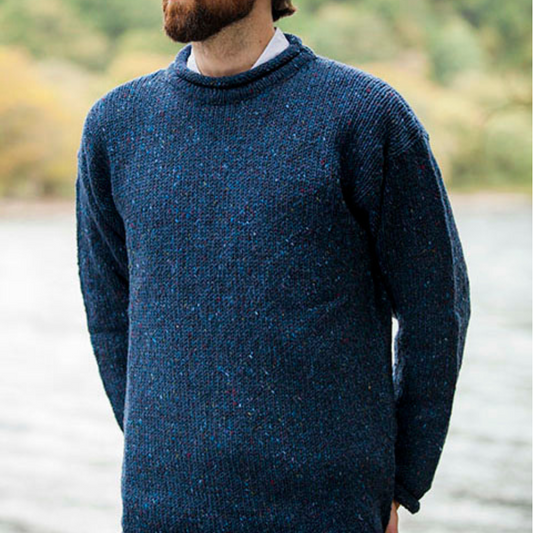 Man wearing navy fleck roll neck Aran sweater, hand-loomed in Donegal from 100% wool