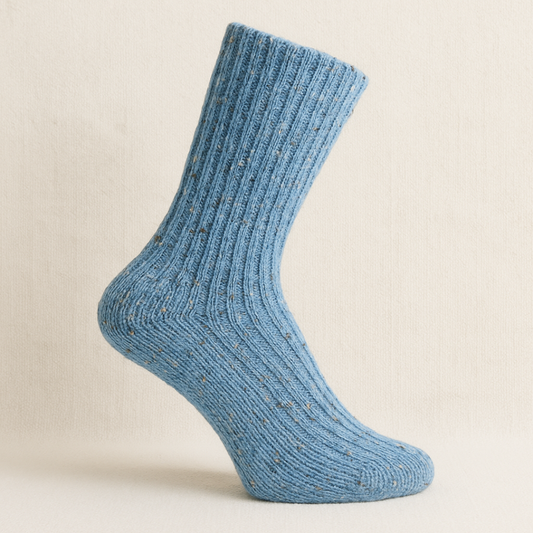 Light blue Donegal wool socks with flecked detail on off-white background