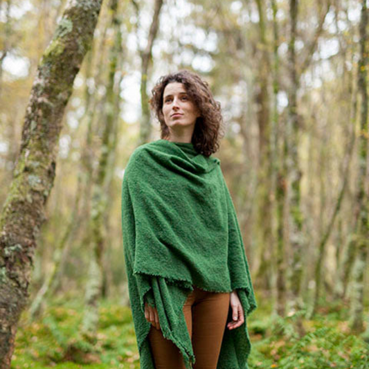 Model wearing the Irish Wool Ruana Cape in forest green, handwoven from soft lambswool in Ireland.