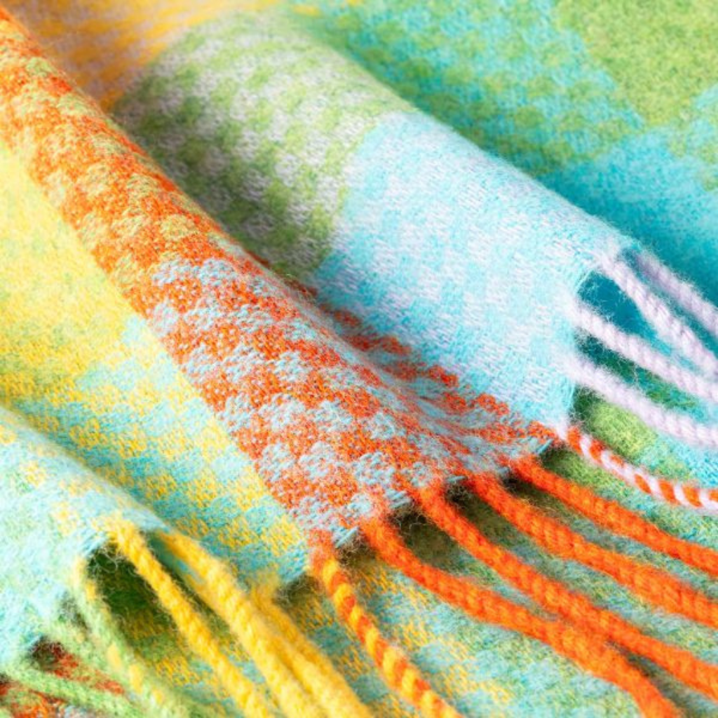 Close-up of the John Hanly Lambswool Baby Blanket showing soft basket-weave texture and colourful pattern.