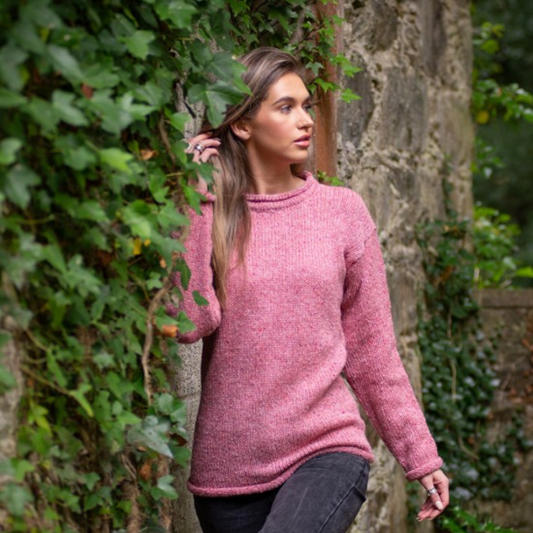 Woman wearing rose fleck roll neck tunic, hand loomed in Donegal from 100% wool