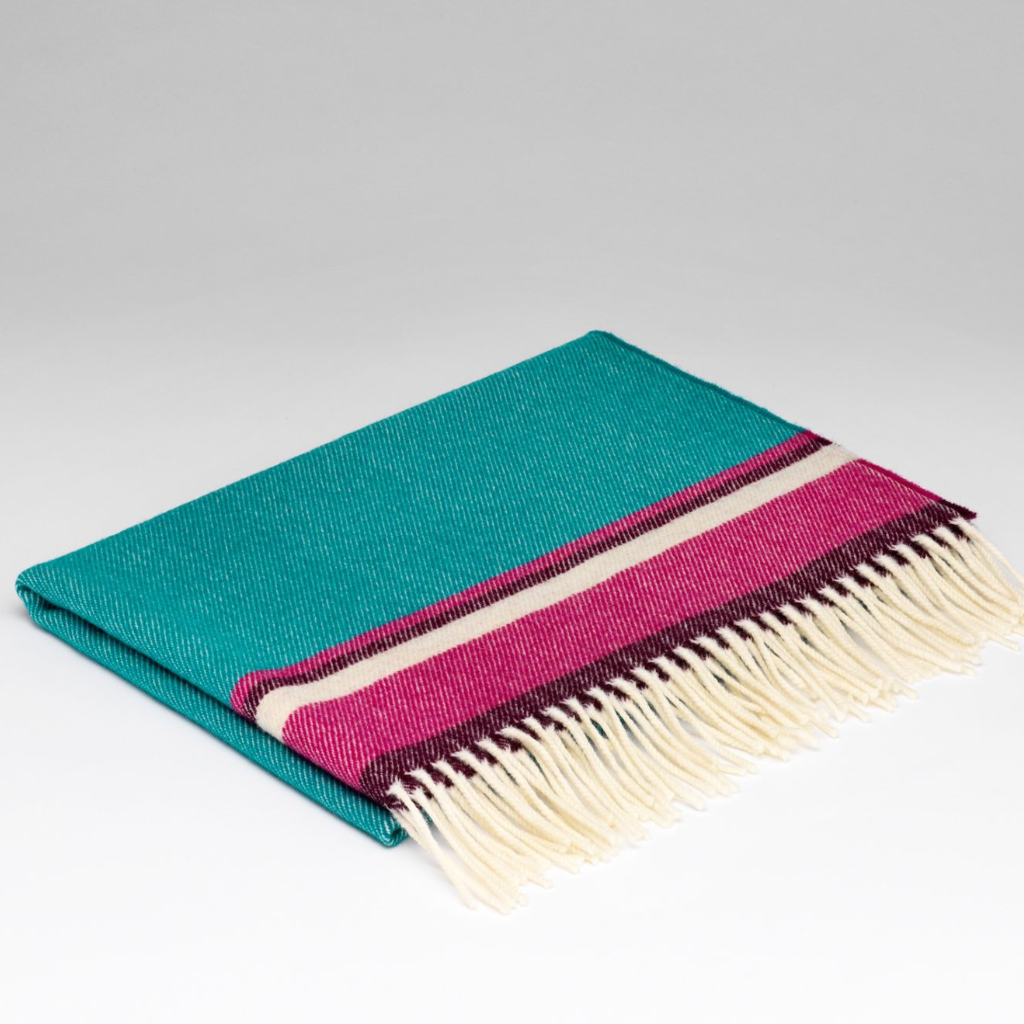 McNutt’s Under the Sea Baby Blanket folded – 100% merino lambswool in green, pink and white with fringe detail