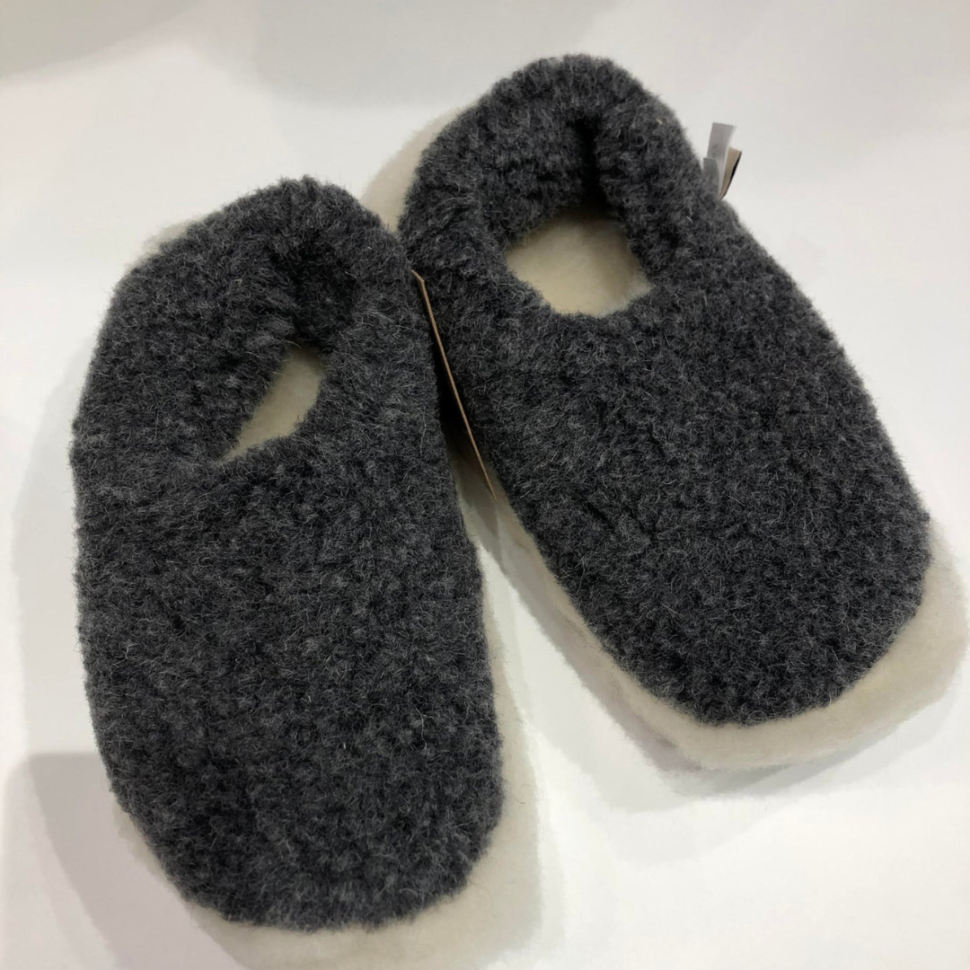 Graphite merino wool slippers – soft wool slip-ons on wooden floor