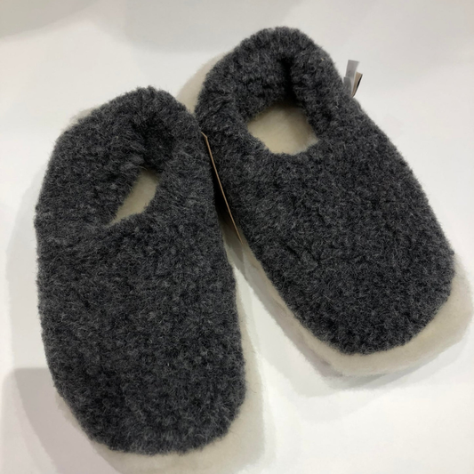 Graphite merino wool slippers – soft wool slip-ons on wooden floor