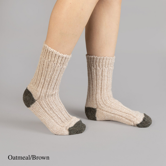 Person wearing oatmeal brown merino wool socks with contrasting heel and toe