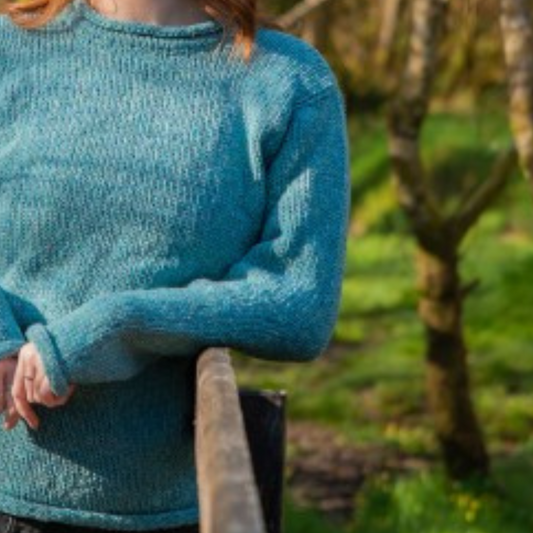 Close-up of turquoise Donegal wool texture and sleeve detail on ladies roll neck tunic